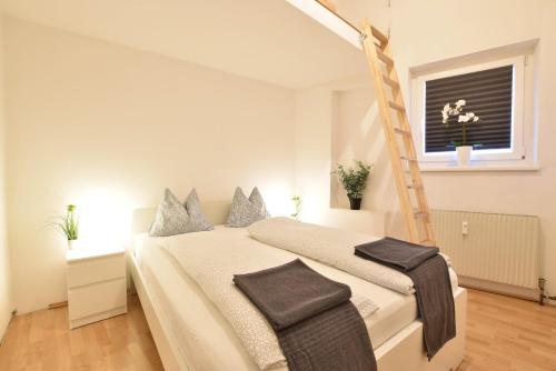 a bedroom with a bed with a ladder in it at Big place in city center with parking in Innsbruck