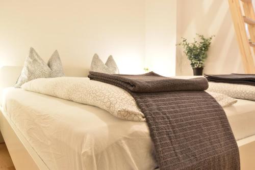 a bedroom with two beds with gray and white pillows at Big place in city center with parking in Innsbruck