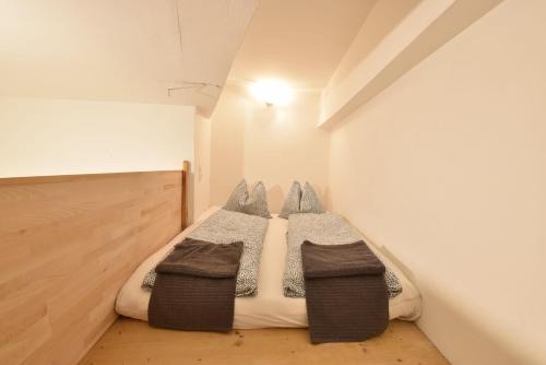 a bedroom with a bed with three pillows at Big place in city center with parking in Innsbruck