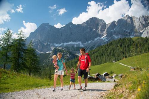 a man and two children standing on a mountain road at Big place in city center with parking in Innsbruck