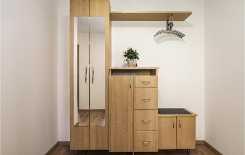 a bathroom with a wooden cabinet and a mirror at Ferienwohnung Mit Ausblick in Braz