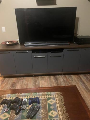 a large flat screen tv sitting on a entertainment center at Korb Residence in Centurion
