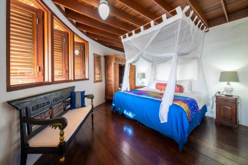 a bedroom with a bed with a canopy at Villa Nirvana Biru Bingin Beach in Uluwatu
