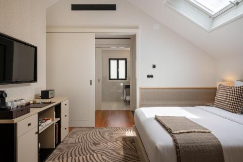 a bedroom with a large bed and a television at Casa da Marechal - Boutique Hotel by Oporto Collection - Adults Only in Porto