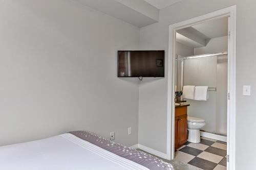 a bedroom with a bed and a television on a wall at The Lambeth by Samsara Resort Private Entry Panorama Top View 2BR and 2BTH in Canmore
