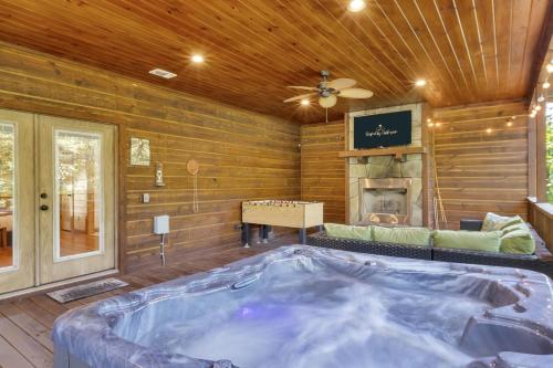 a jacuzzi tub in a room with a fireplace at Gorgeous Idyllic Cabin w Hot Tub and Fire Pit Quittin Time is Secluded Romantic Oasis w Luxury Bathroom Double Shower and Bathtub Foosball Table in Broken Bow