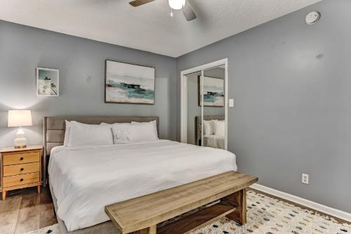 a bedroom with a large white bed and a table at Wilmington Island Retreat in Savannah