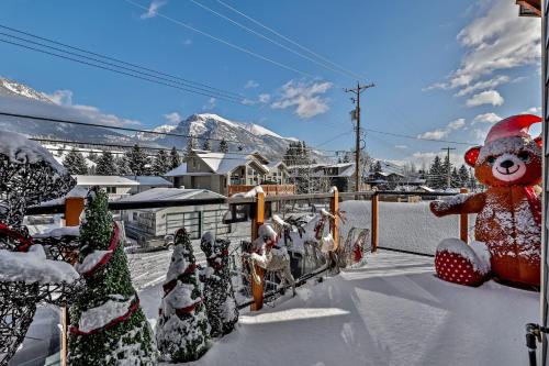 a teddy bear and christmas trees are covered in snow at The Parq by Samsara Resort Top View Downtown 4BR & 3BTH in Canmore