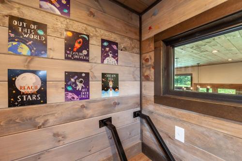 a room with wooden walls with a window and signs at Bowling Waterfront Luxury MtnViews Pool Sleeps12 in Sevierville