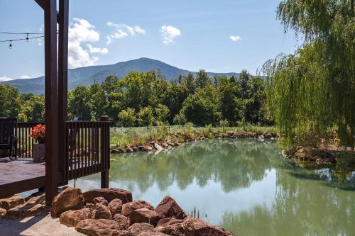 a view of a pond with mountains in the background at Bowling Waterfront Luxury MtnViews Pool Sleeps12 in Sevierville