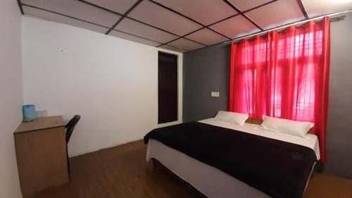 a bedroom with a bed and a red window at Thrillomania Mcleodganj in Dharamshala
