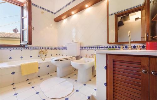 a bathroom with a toilet and a tub and a sink at Migliano in Fibbialla