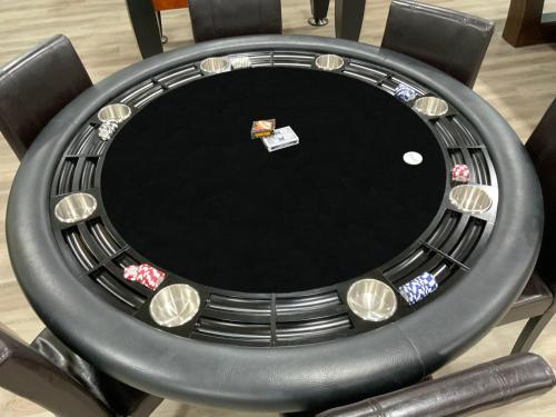 a black poker table with a lot of poker chips at Buddha Mansion Luxury Resort - 8BR Modern, HotTub, Huge pool, Sauna, BBQ grill, Game Room in Las Vegas