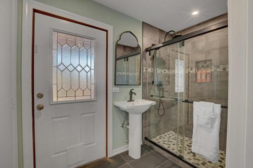 a bathroom with a sink and a shower with a glass door at Buddha Mansion Luxury Resort - 8BR Modern, HotTub, Huge pool, Sauna, BBQ grill, Game Room in Las Vegas