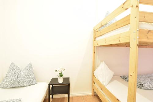a bedroom with a bunk bed and a bedside table at Huge Apartment in Awesome Location with parking in Innsbruck