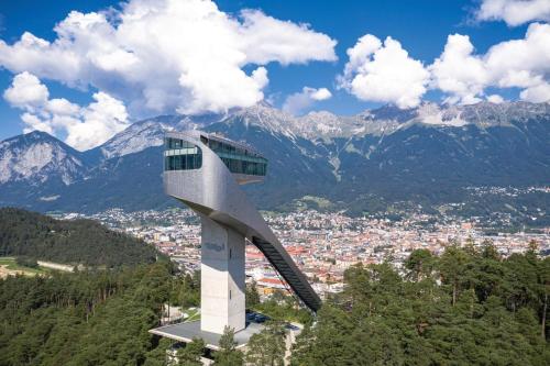 a building on top of a mountain with a city at Huge Apartment in Awesome Location with parking in Innsbruck