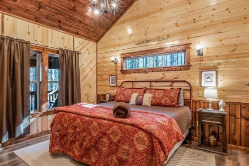 a bedroom with a bed with a dog laying on it at Large Luxury 2BR Cabin w Hot Tub Double Trouble was designed for fun comfort and memories minutes from buzzling Hochatown and beautiful Beaver Bend State Park in Broken Bow