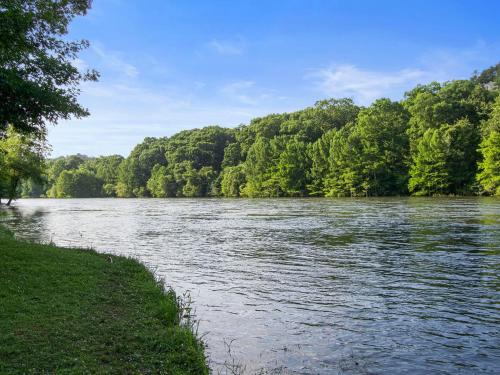 a river with trees on the side of it at Large Luxury 2BR Cabin w Hot Tub Double Trouble was designed for fun comfort and memories minutes from buzzling Hochatown and beautiful Beaver Bend State Park in Broken Bow