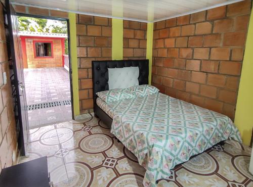 a bedroom with a bed in a brick wall at Finca Villa Hermosa in Alcalá