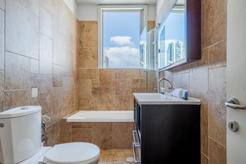 a bathroom with a toilet and a tub and a sink at 2BR - 2 12 Hei be-Iyar St Tel aviv in Tel Aviv