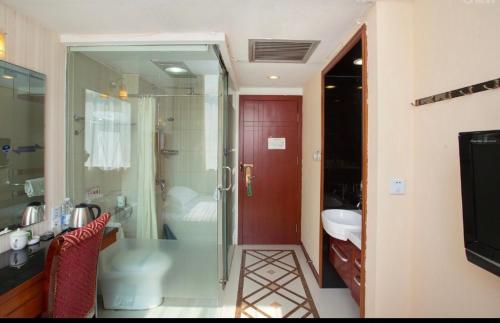 a bathroom with a sink and a toilet and a red door at Shanghai YUHANG Hotel in Shanghai