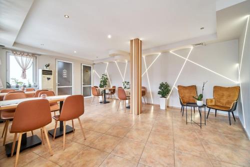 a dining room with chairs and tables in a room at Hotel Amfora in St. St. Constantine and Helena