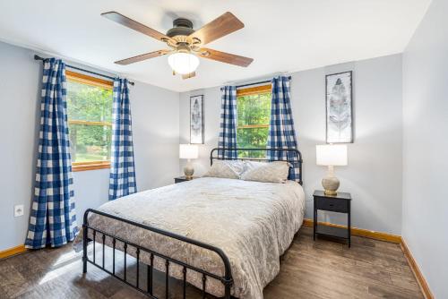 a bedroom with a bed and a ceiling fan at Lakefront Cottage w Hot Tub, Fire Pit, WiFi, Grill & Screened-In Porch in Morton Grove