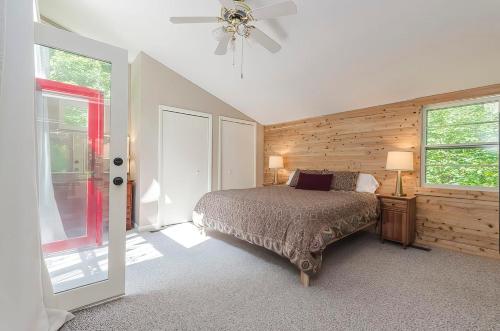 a bedroom with a bed and a ceiling fan at Secluded Oasis w Hot Tub, Screened-in Porch, WiFi! in Berkeley Springs