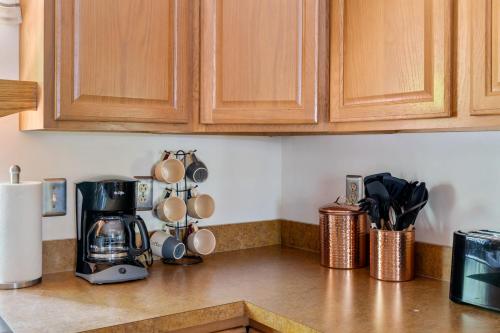 a kitchen counter with a coffeemaker and a coffee maker at Modern decor, Hot Tub, Fire Pit, Grill, & Games in Berkeley Springs