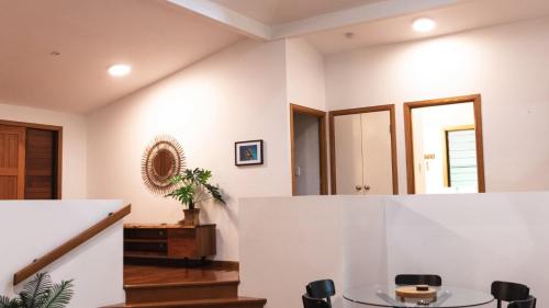 a dining room with a table and chairs at Picnic House, Luxurious Tropical House in Picnic Bay
