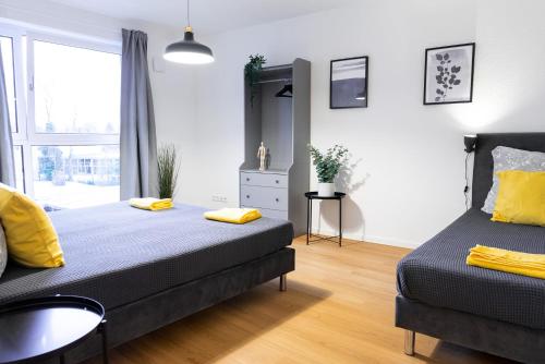 a bedroom with two beds and a sink and a window at 122 Luruper 2 in Hamburg