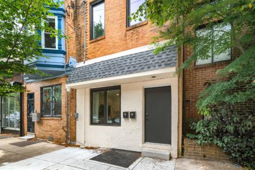 a brick building with a door on a street at 2BR in Heart of Queen Village - walk to everything! in Philadelphia
