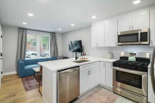 a kitchen with white cabinets and a stove top oven at 2BR in Heart of Queen Village - walk to everything! in Philadelphia
