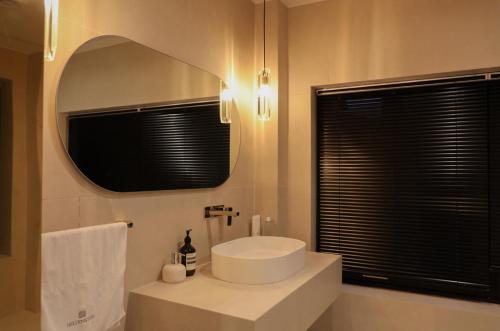 a bathroom with a white sink and a mirror at Jeonju Hanok Village, Maison14 in Jeonju