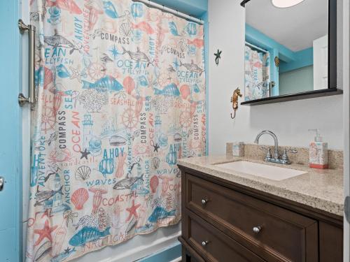une salle de bain avec un rideau de douche et un lavabo dans l'établissement Little Cove Resort, à Taft