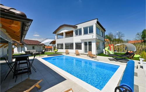 a swimming pool in front of a house at Beautiful Home In Vinica Breg With Wifi in Cestica