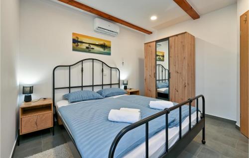 CesticaにあるBeautiful Home In Vinica Breg With Wifiのベッドルーム1室(ベッド1台付)、木製キャビネットが備わります。
