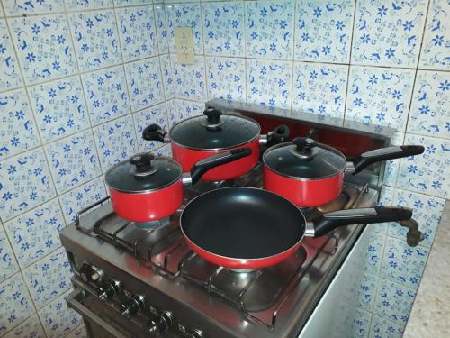 a pair of pots and pans on a stove at Quinta House in Mendoza