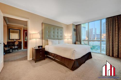 a hotel room with a bed and a large window at MGM Signature-03-821 1Br2Ba F1 Strip View Balcony in Las Vegas