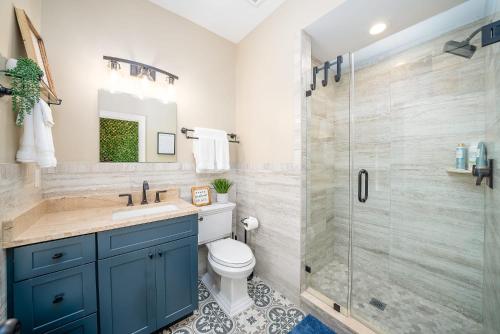 a bathroom with a toilet and a glass shower at Quaint Studio in the Heart of Downtown St Augustine in Saint Augustine