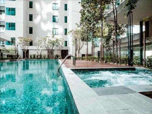 a swimming pool in front of a building at Inspired Homes @ Summer Suite in Kuala Lumpur