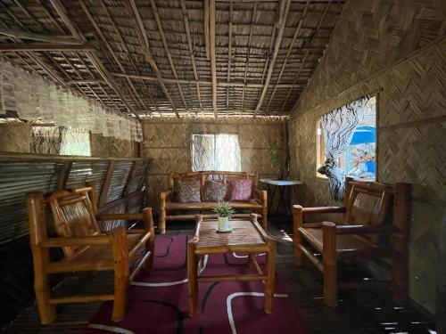 Botolan的住宿－Jardim Da Praia，一间带椅子、桌子和沙发的房间