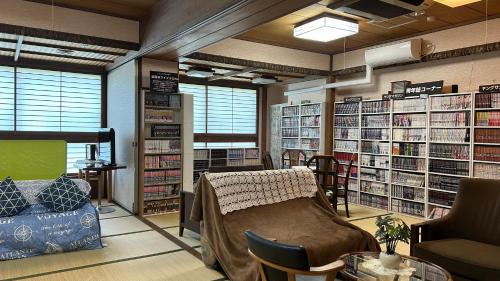 a library with a table and chairs and shelves of books at Hotel Tsukuba Hills Gakuen-odori in Tsukuba