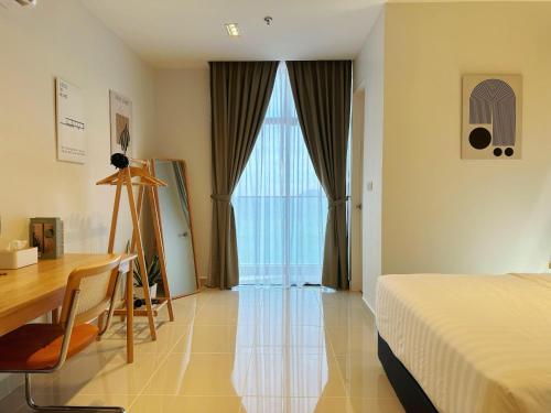 a bedroom with a bed and a desk and a table at THE SHORE SEAVIEW Centre Of The City in Kota Kinabalu