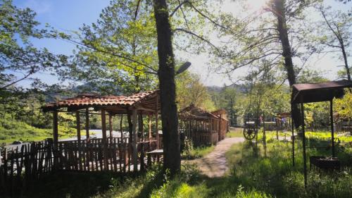 a wooden fence with a gazebo in a park at Guesthouse - Family Hotel in Bagdatʼi