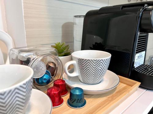 a table with cups and a microwave on a counter at Apartments Ana & Ita in Novalja
