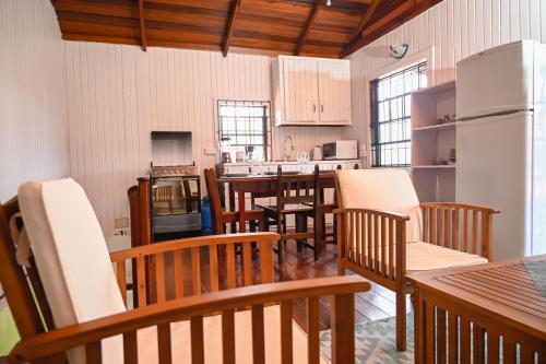 cocina grande con sillas de madera y nevera en The Cottages - Unit 1 en Soufrière