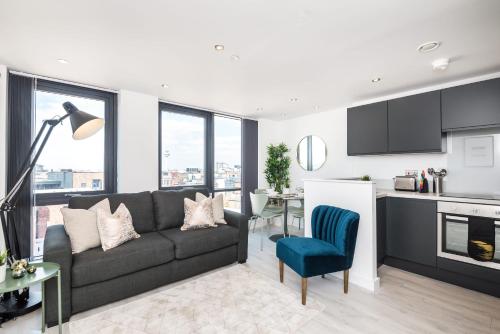 a living room with a couch and a kitchen at Host & Stay - The Baltic Penthouse 3 in Liverpool