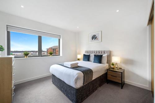 a bedroom with a large bed and a large window at Host & Stay - Waterfront View in Liverpool