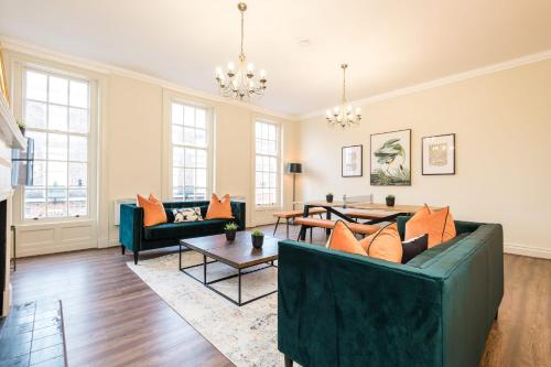 a living room with couches and a table at Host & Stay - The Rodney Townhouse in Liverpool